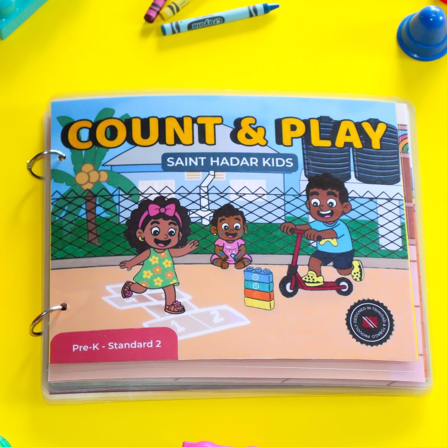 Children's book titled 'Count & Play' by Saint Hadar Kids on a yellow background with crayons.