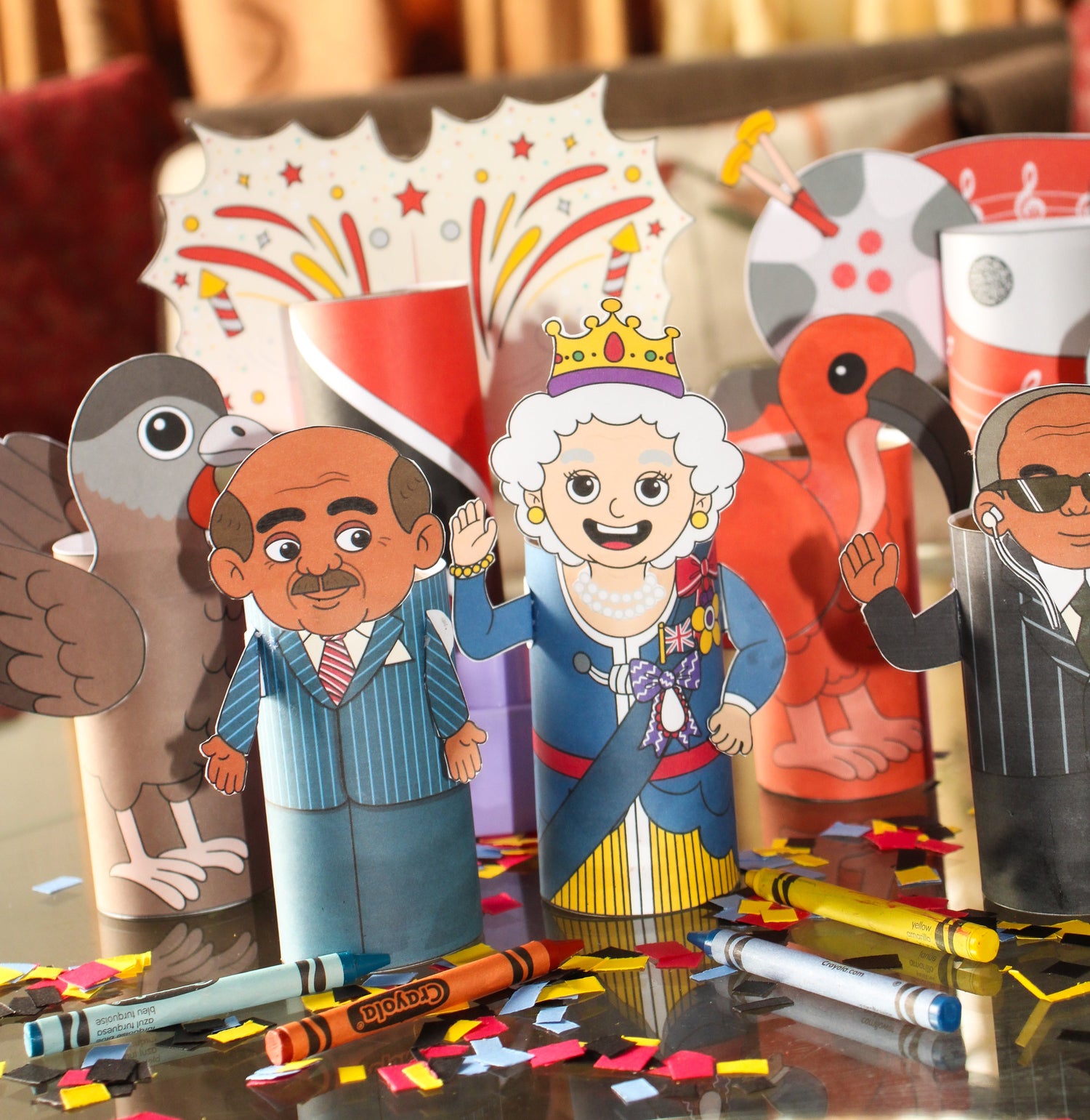 Cartoon cutouts of Queen Elizabeth the second, the first president, prime minister and governor general of Trinidad and Tobago, with the Scarlet Ibis, Cocrico, national flag, steelpan and fireworks.